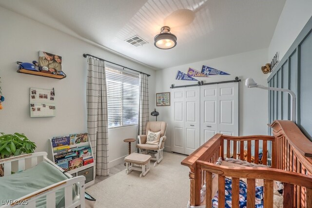 bedroom featuring a closet, visible vents, baseboards, and carpet floors