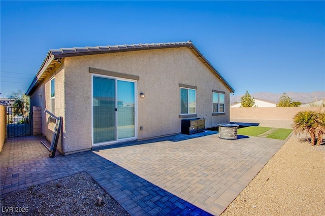 back of house with a patio area, stucco siding, and fence