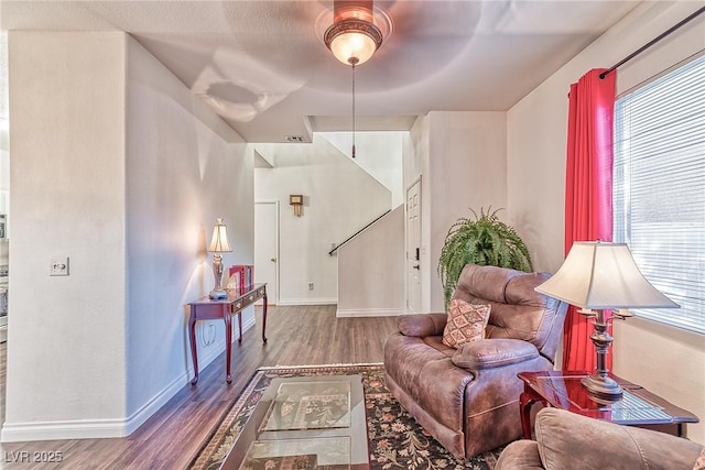 sitting room with a wealth of natural light, baseboards, and wood finished floors