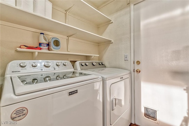 laundry room with washer and clothes dryer and laundry area