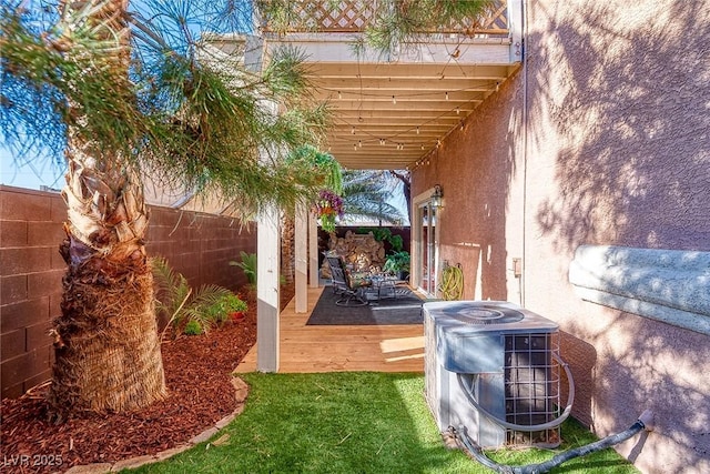 view of yard featuring a deck, central air condition unit, and a fenced backyard