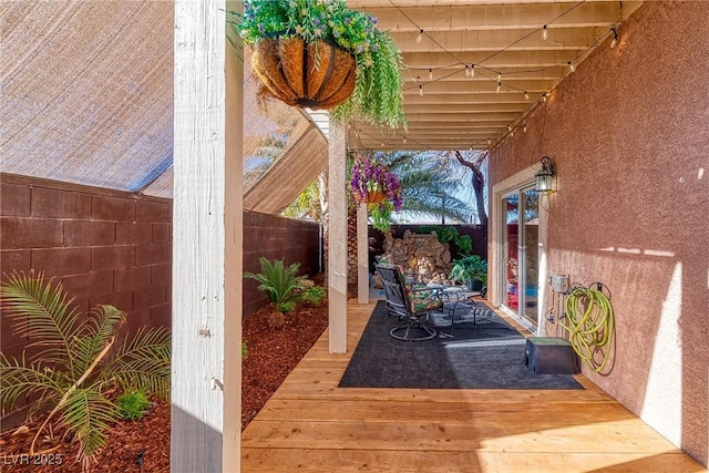 view of patio with a wooden deck and a fenced backyard