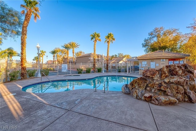 community pool featuring a patio and fence