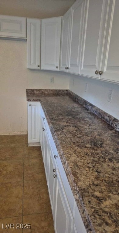 kitchen featuring white cabinetry and tile patterned flooring