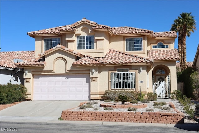 mediterranean / spanish-style home featuring a gate, a garage, driveway, and stucco siding