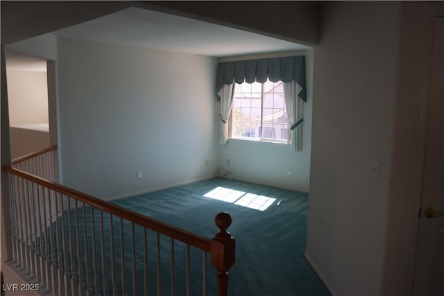 empty room with baseboards and carpet floors