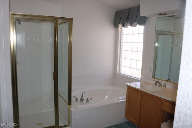 bathroom with a bath, a stall shower, and vanity