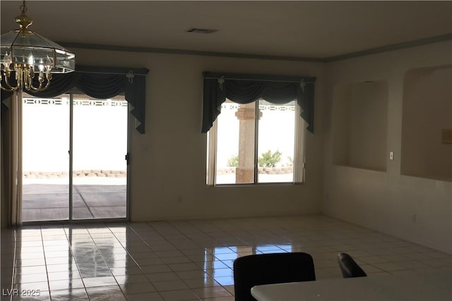 interior space featuring visible vents, a notable chandelier, ornamental molding, and tile patterned flooring