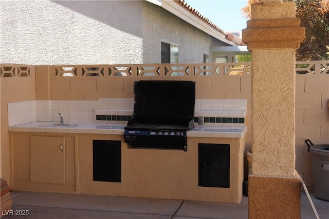 view of patio / terrace with area for grilling and fence