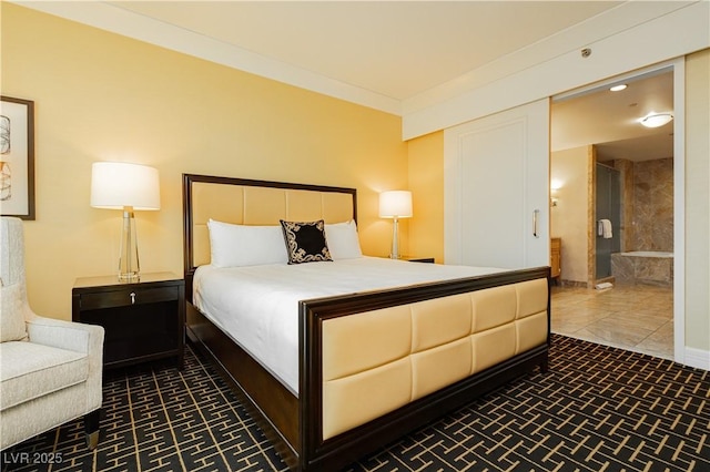 bedroom with ensuite bath, baseboards, and ornamental molding