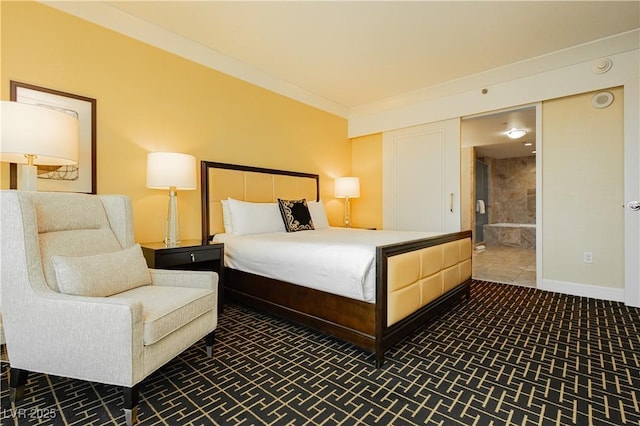 bedroom with ensuite bath, baseboards, and ornamental molding