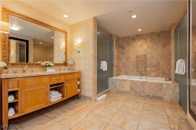 bathroom featuring a sink, recessed lighting, a shower stall, double vanity, and a bath