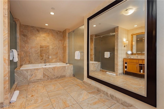 bathroom with a stall shower, recessed lighting, tile walls, a bath, and vanity