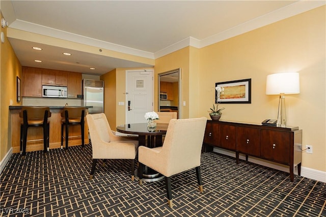 dining area with crown molding, recessed lighting, and baseboards