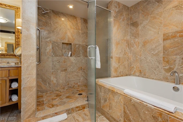 full bathroom featuring vanity, a garden tub, and a shower stall