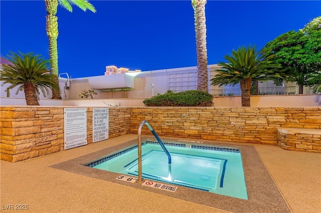 view of pool featuring a hot tub