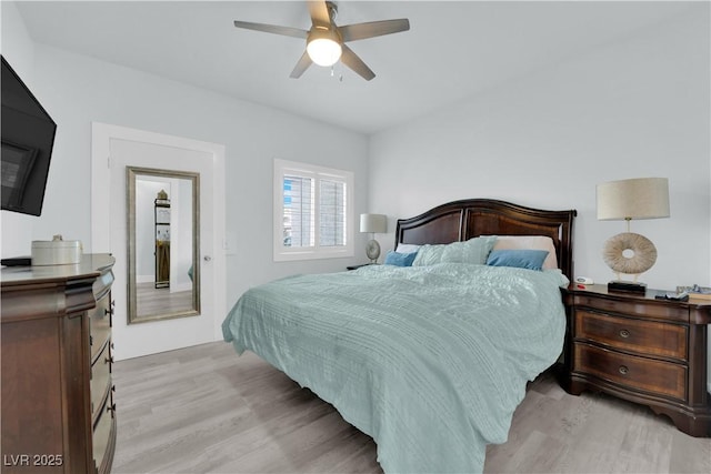 bedroom with light wood-style flooring and a ceiling fan