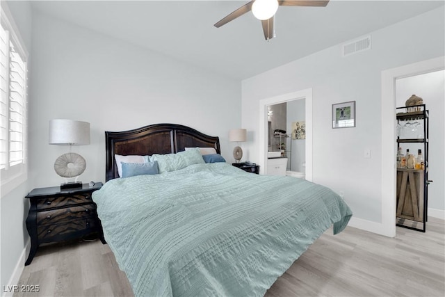 bedroom featuring visible vents, connected bathroom, ceiling fan, baseboards, and light wood-type flooring