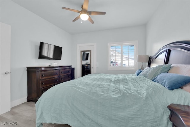 bedroom with baseboards, light wood-style floors, and a ceiling fan