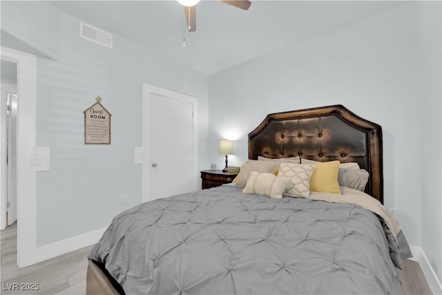 bedroom with visible vents, ceiling fan, light wood-type flooring, and baseboards