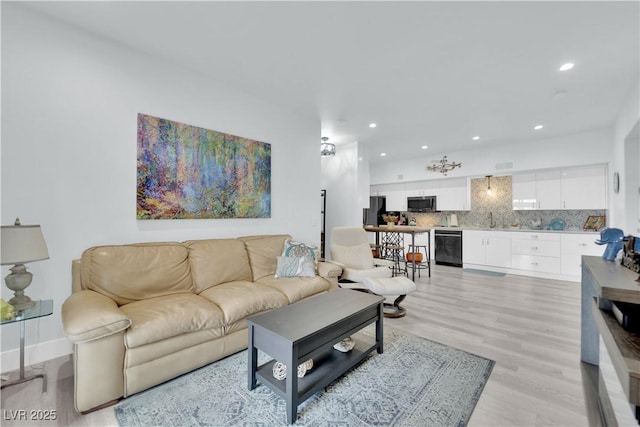 living room featuring recessed lighting and light wood finished floors