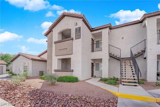 view of front of home with stucco siding and stairs