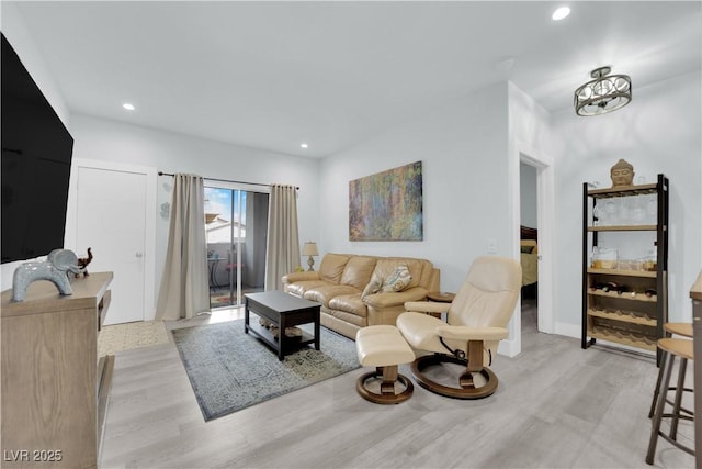 living area with recessed lighting and light wood-style floors