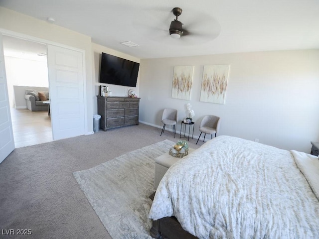 bedroom with a ceiling fan and carpet