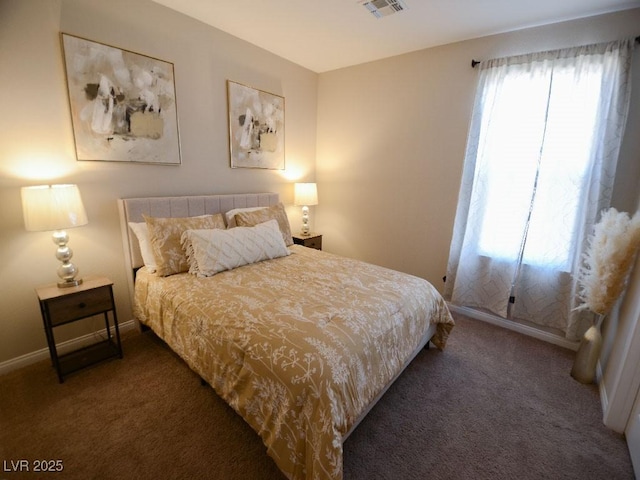 carpeted bedroom with visible vents and baseboards