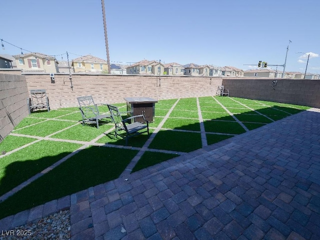 view of yard with a fenced backyard and a residential view