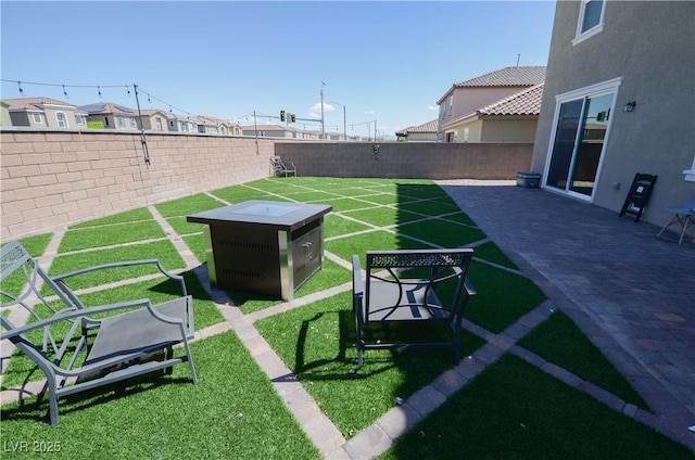 view of home's community featuring a fenced backyard, a patio area, and a yard