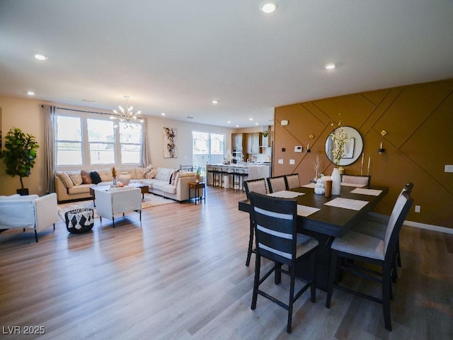 dining area with an inviting chandelier, recessed lighting, and wood finished floors