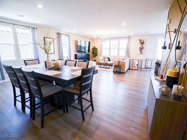 dining room with recessed lighting, wood finished floors, visible vents, and a chandelier