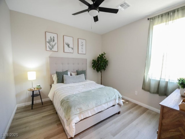 bedroom featuring light wood-style flooring, multiple windows, and visible vents