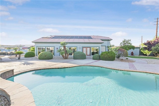 outdoor pool featuring a patio area and french doors