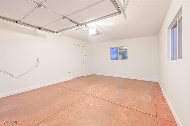 garage with baseboards and a garage door opener