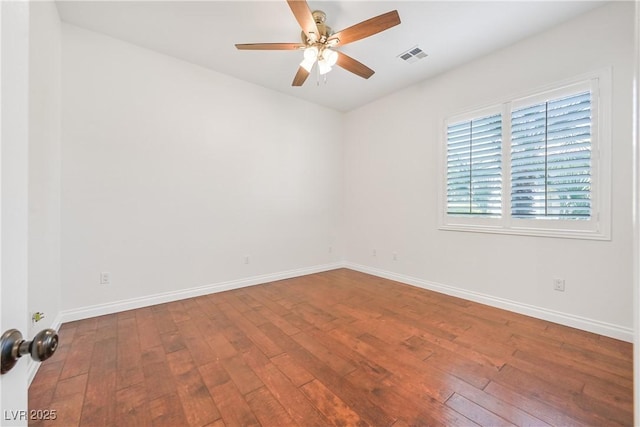 unfurnished room with wood-type flooring, visible vents, baseboards, and ceiling fan