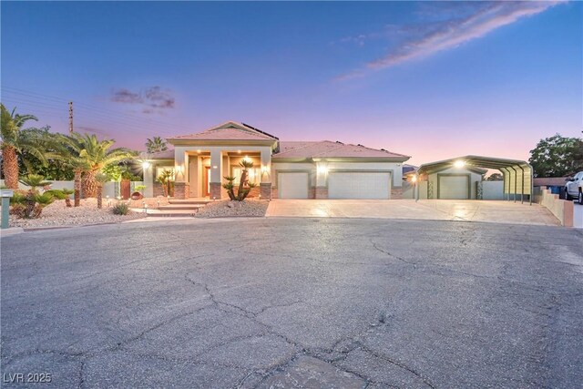 view of front of house with concrete driveway and stucco siding