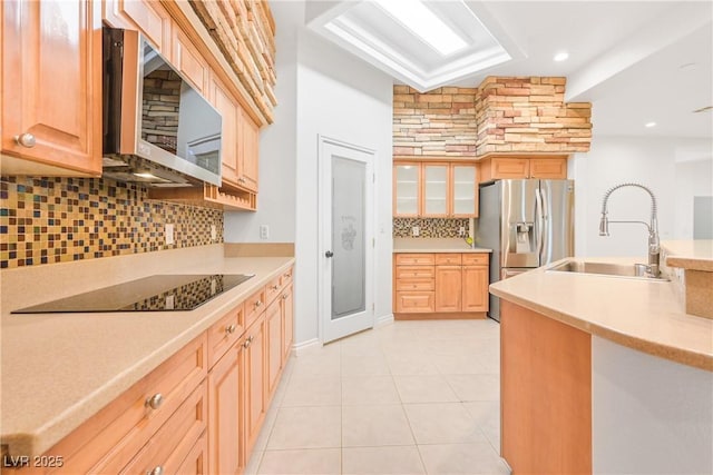kitchen featuring light countertops, decorative backsplash, a sink, and stainless steel appliances