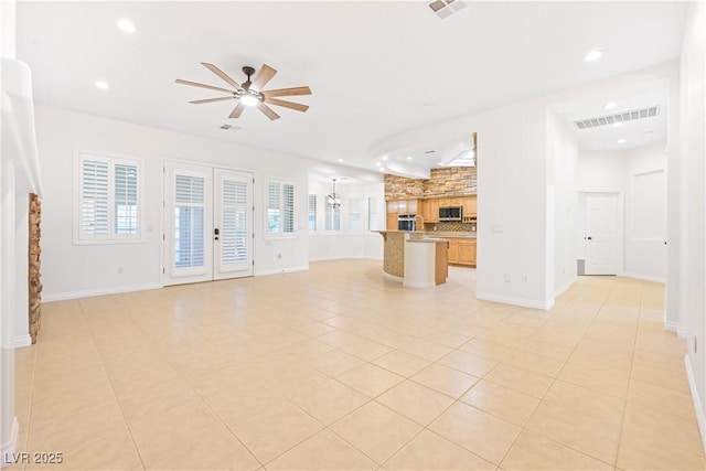 unfurnished living room with ceiling fan, visible vents, recessed lighting, light tile patterned flooring, and baseboards