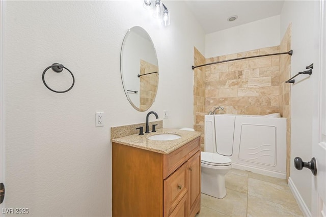 bathroom with toilet, vanity, and tile patterned flooring