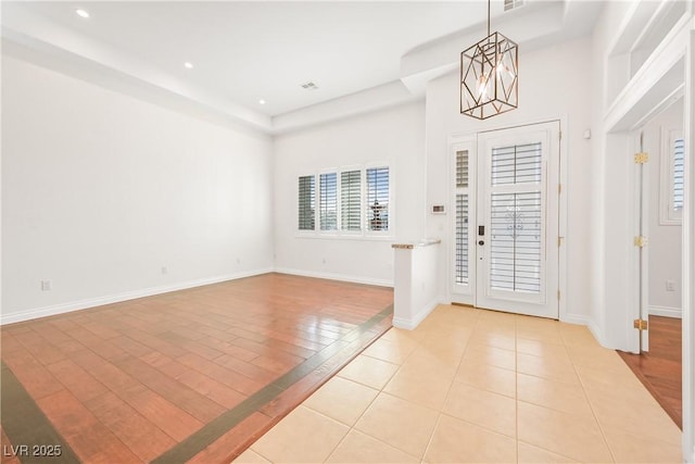 entryway featuring recessed lighting, light tile patterned floors, baseboards, and an inviting chandelier