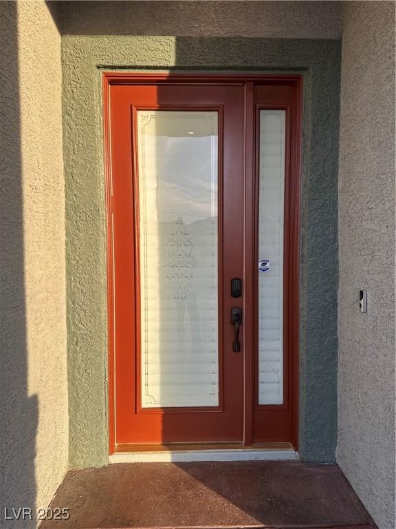 property entrance with stucco siding