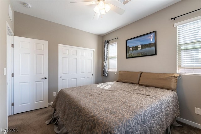 bedroom with a closet, carpet flooring, baseboards, and a ceiling fan