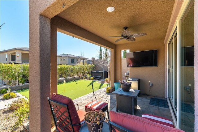 view of patio / terrace with a ceiling fan and fence