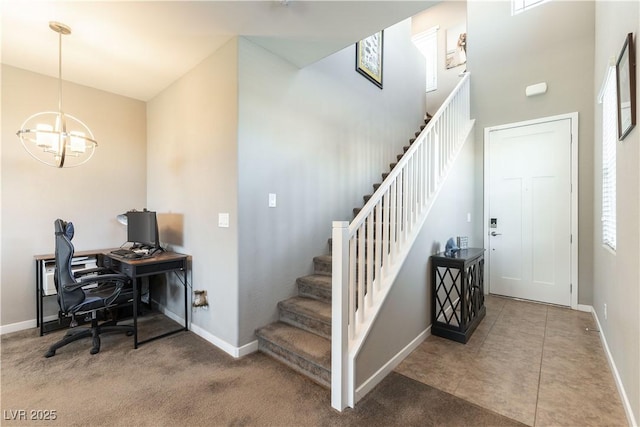 office space with a chandelier, tile patterned floors, and baseboards