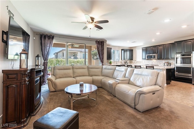 living area featuring recessed lighting and a ceiling fan