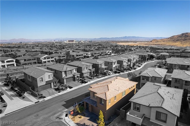 birds eye view of property with a mountain view and a residential view