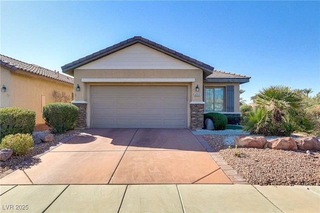 view of front facade with stucco siding, driveway, stone siding, an attached garage, and a tiled roof