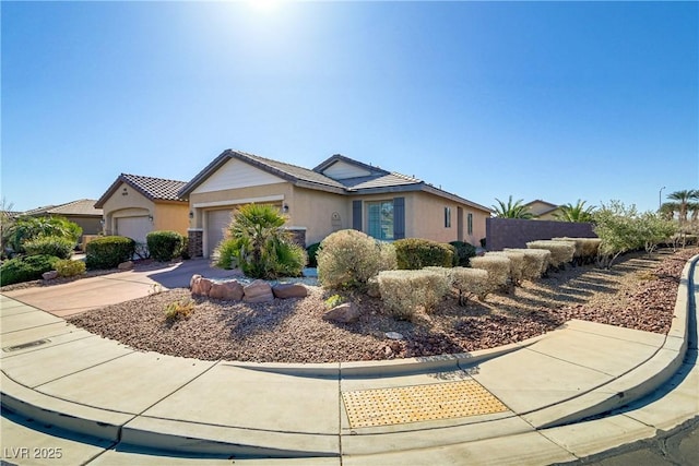 ranch-style home featuring stucco siding, concrete driveway, an attached garage, and fence